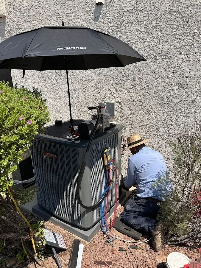 HVAC technician performing outdoor AC maintenance in Bee Cave